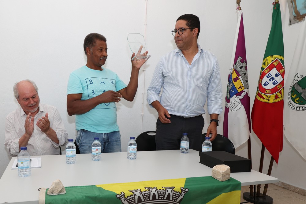Presidente da Junta de Freguesia de S. Sebastião, Nuno Costa, entrega placa ao presidente da assembleia geral da Associação Desportiva e Cultural Os Africanos, José António Moreno